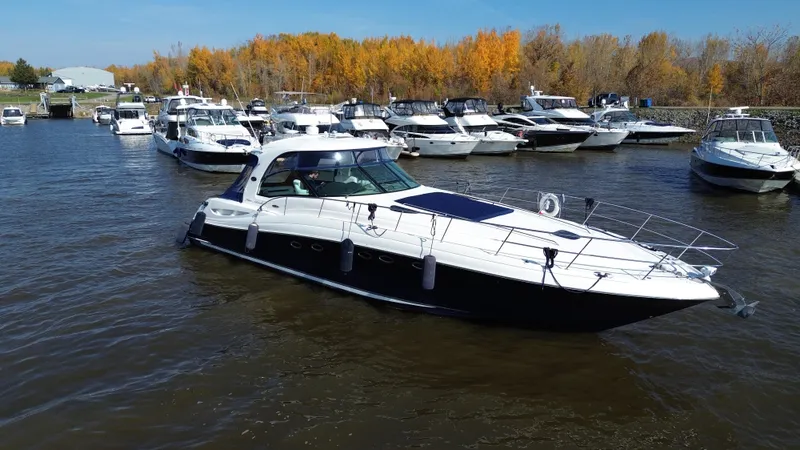  Yacht Photos Pics 2005 Sea Ray Sundancer 520 yacht docked in a marina with autumn trees.