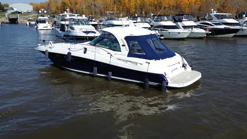  Yacht Photos Pics 2005 Sea Ray Sundancer 520 yacht docked in a marina with other boats.