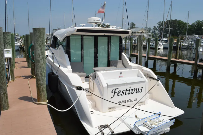  Yacht Photos Pics 2019 Tiara Yachts C39 Coupe docked, rear view, named "Festivus," in a marina setting.