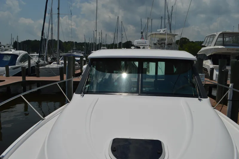  Yacht Photos Pics 2019 Tiara Yachts C39 Coupe docked at marina under cloudy sky.