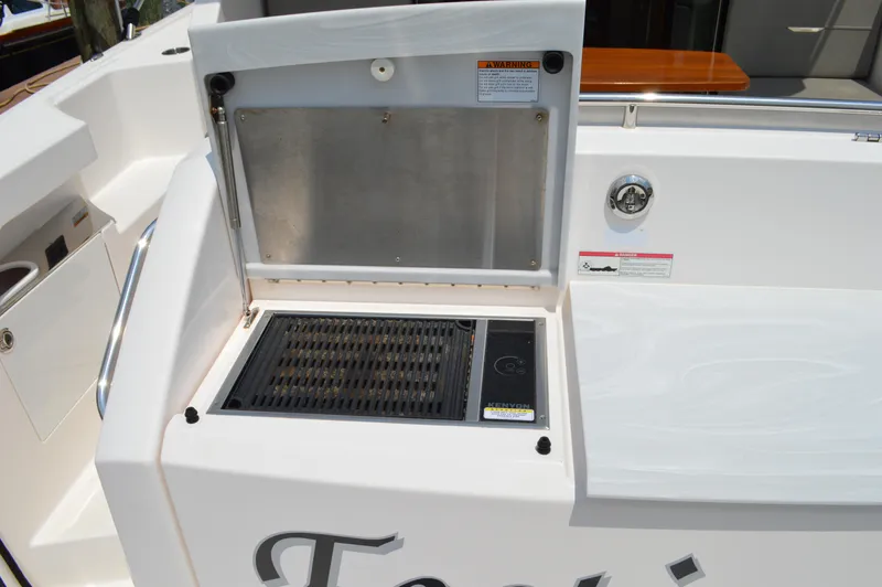  Yacht Photos Pics Outdoor grill on 2019 Tiara Yachts C39 Coupe deck, featuring stainless steel finish.
