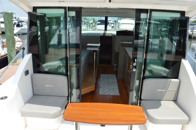  Yacht Photos Pics 2019 Tiara Yachts C39 Coupe interior with seating and table, docked at marina.
