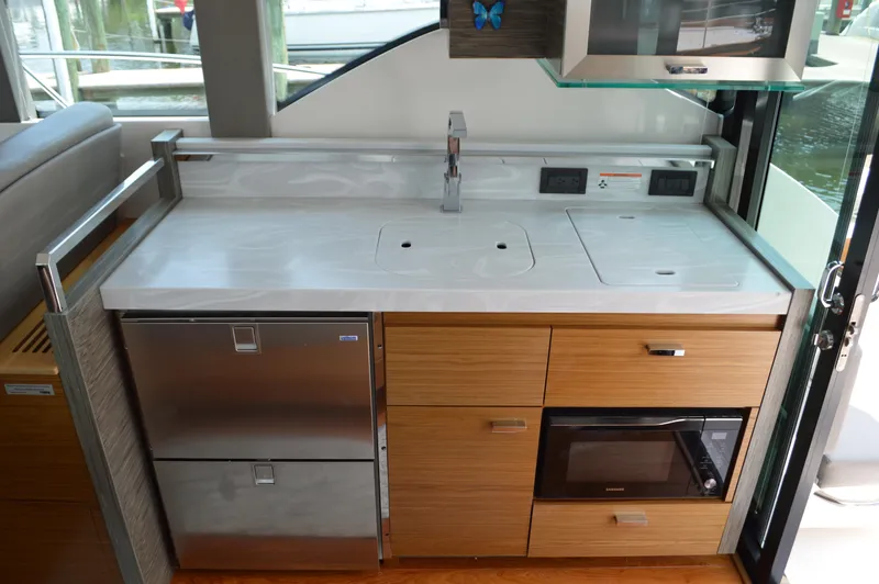  Yacht Photos Pics Modern kitchen area in 2019 Tiara Yachts C39 Coupe with sleek appliances and cabinetry.