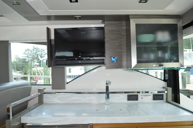  Yacht Photos Pics Interior of 2019 Tiara Yachts C39 Coupe with modern kitchen and TV setup.
