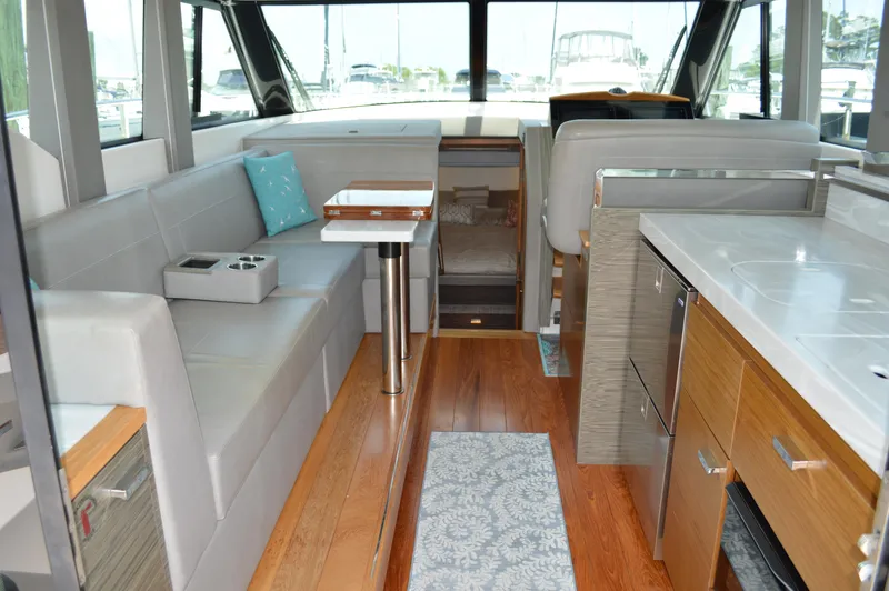  Yacht Photos Pics Interior of 2019 Tiara Yachts C39 Coupe, featuring modern seating and wooden flooring.