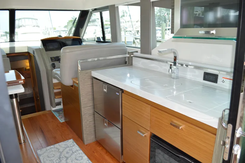  Yacht Photos Pics 2019 Tiara Yachts C39 Coupe interior with modern kitchen and helm station.