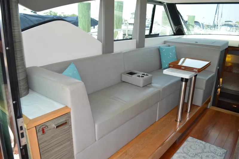  Yacht Photos Pics 2019 Tiara Yachts C39 Coupe interior with gray seating and wooden accents.
