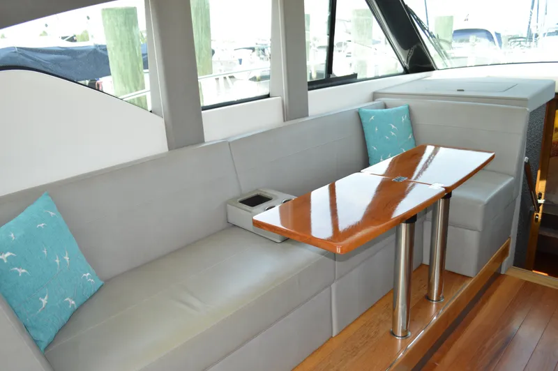  Yacht Photos Pics 2019 Tiara Yachts C39 Coupe interior with sleek seating and polished wooden table.
