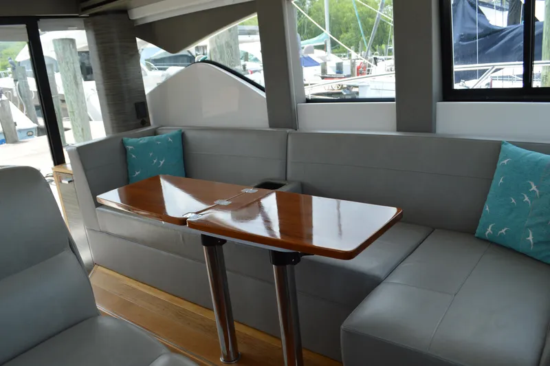  Yacht Photos Pics 2019 Tiara Yachts C39 Coupe interior with sleek seating and wooden table.