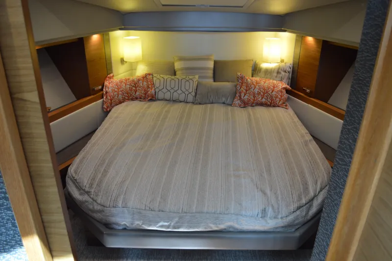  Yacht Photos Pics Luxurious bedroom interior of 2019 Tiara Yachts C39 Coupe with cozy bedding and ambient lighting.
