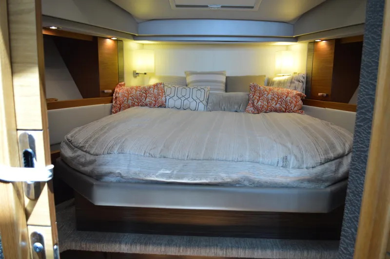  Yacht Photos Pics Luxurious bedroom interior of 2019 Tiara Yachts C39 Coupe with cozy bedding and ambient lighting.