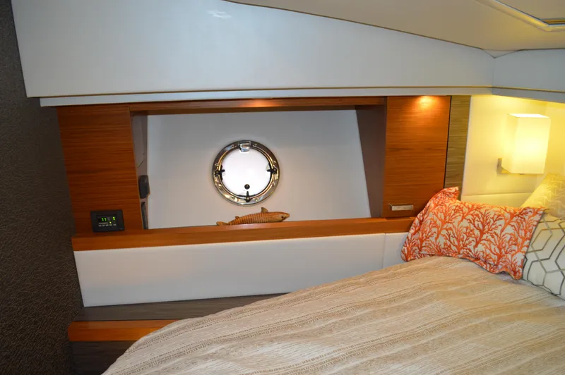  Yacht Photos Pics 2019 Tiara Yachts C39 Coupe interior with cozy bed and porthole window.