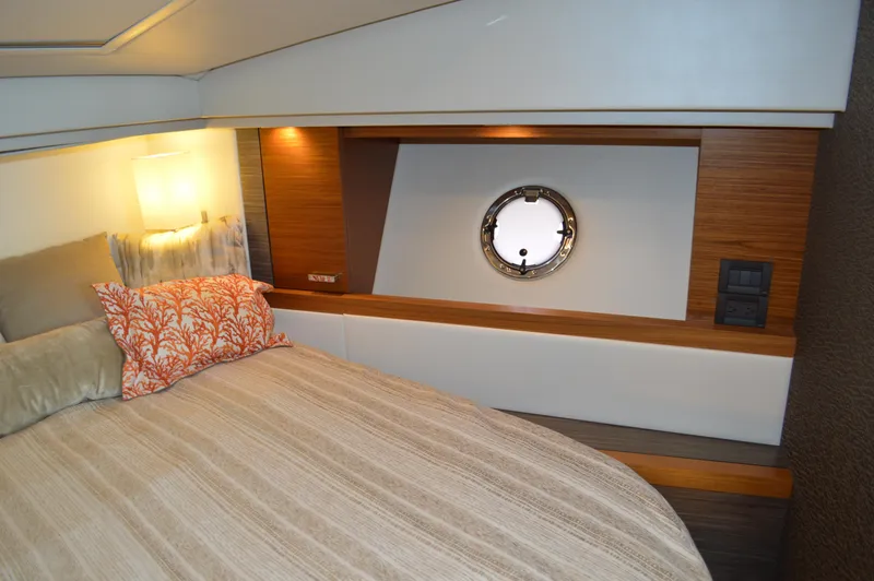  Yacht Photos Pics 2019 Tiara Yachts C39 Coupe cabin interior with bed, porthole, and modern decor.