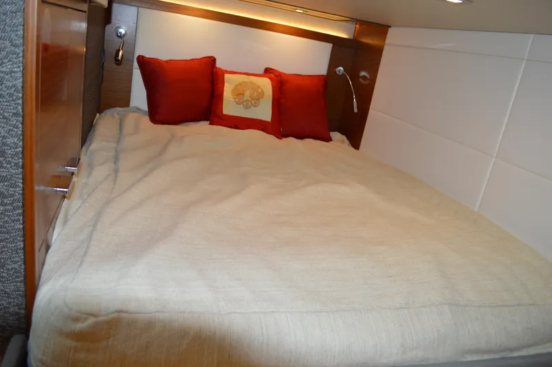  Yacht Photos Pics Cozy bedroom in 2019 Tiara Yachts C39 Coupe with red pillows and beige bedding.