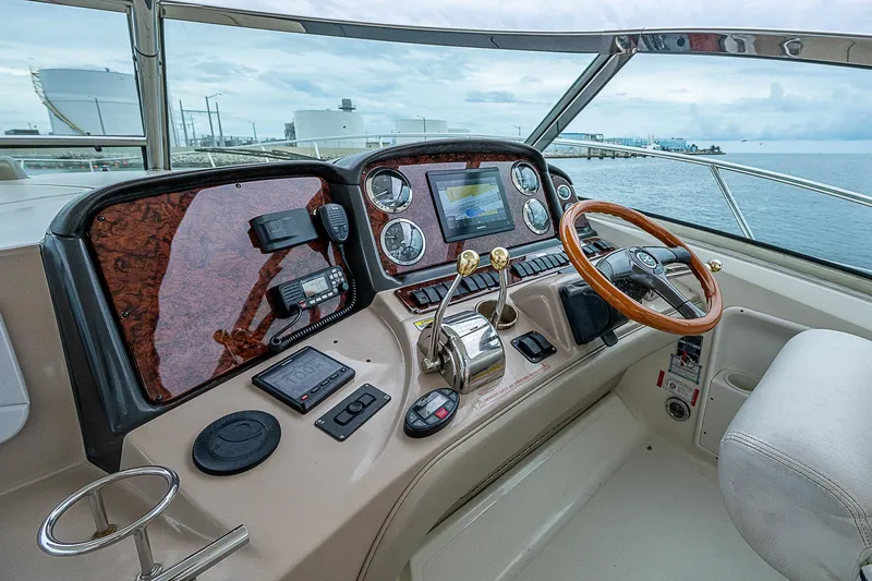 Grand Admiral Yacht Photos Pics 2004 Sea Ray 420 Sundancer helm with modern navigation controls and wooden steering wheel.
