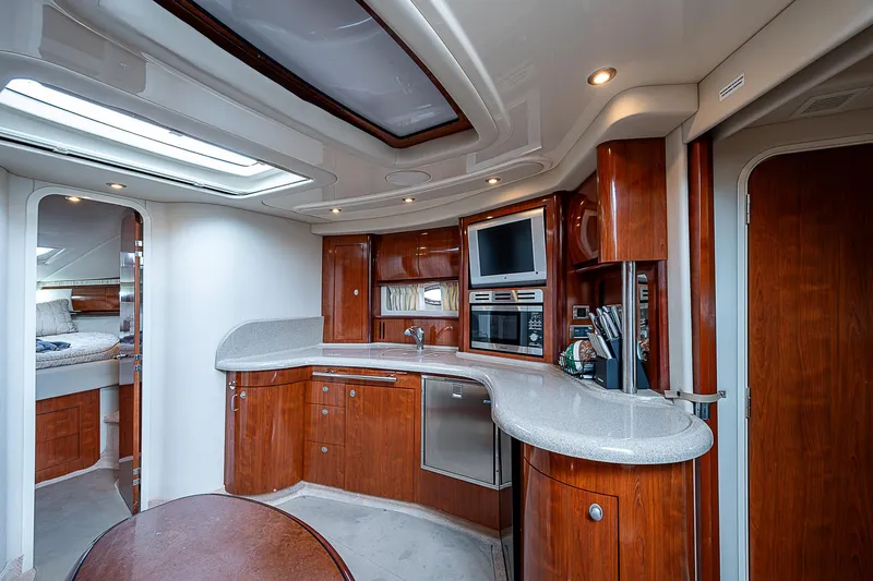 Grand Admiral Yacht Photos Pics Luxurious 2004 Sea Ray 420 Sundancer yacht interior with modern kitchen and wood finishes.