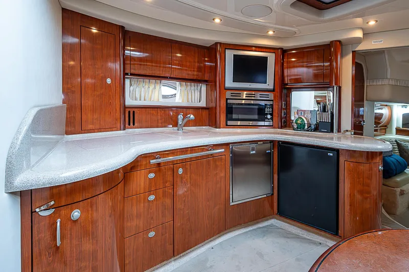 Grand Admiral Yacht Photos Pics Luxurious 2004 Sea Ray 420 Sundancer yacht kitchen with wood cabinetry and modern appliances.