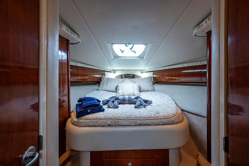 Grand Admiral Yacht Photos Pics Luxurious cabin interior of 2004 Sea Ray 420 Sundancer yacht with plush bedding.