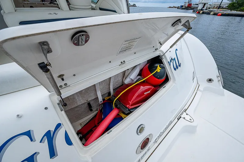 Grand Admiral Yacht Photos Pics Open storage compartment on 2004 Sea Ray 420 Sundancer boat, containing life jackets and pool noodles.