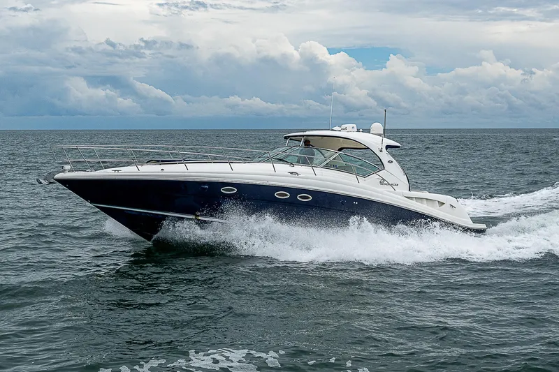 Grand Admiral Yacht Photos Pics 2004 Sea Ray 420 Sundancer cruising on open water under cloudy skies.
