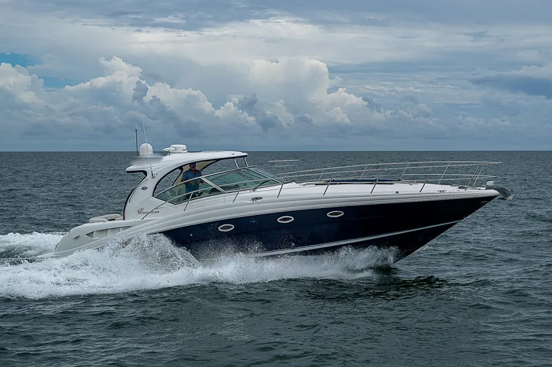 Grand Admiral Yacht Photos Pics 2004 Sea Ray 420 Sundancer cruising on open water under cloudy skies.