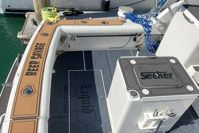 Beer Money Yacht Photos Pics 2004 Topaz 32 Express boat deck with "Beer Savage" and "Seeker" branding, docked at marina.