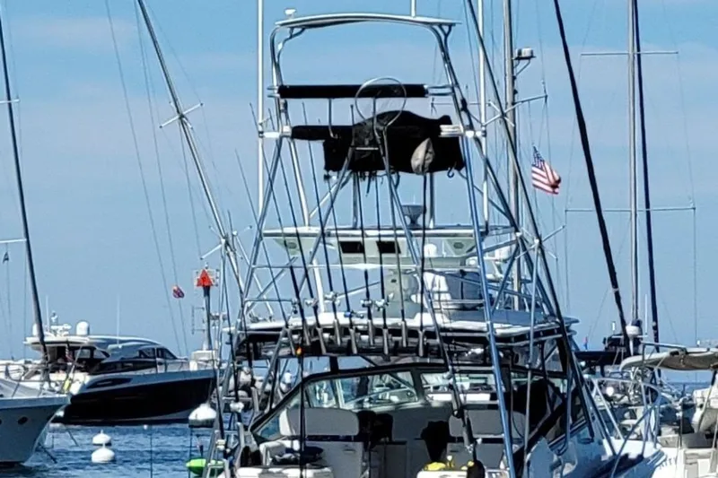 Beer Money Yacht Photos Pics 2004 Topaz 32 Express boat docked in a marina with other vessels.