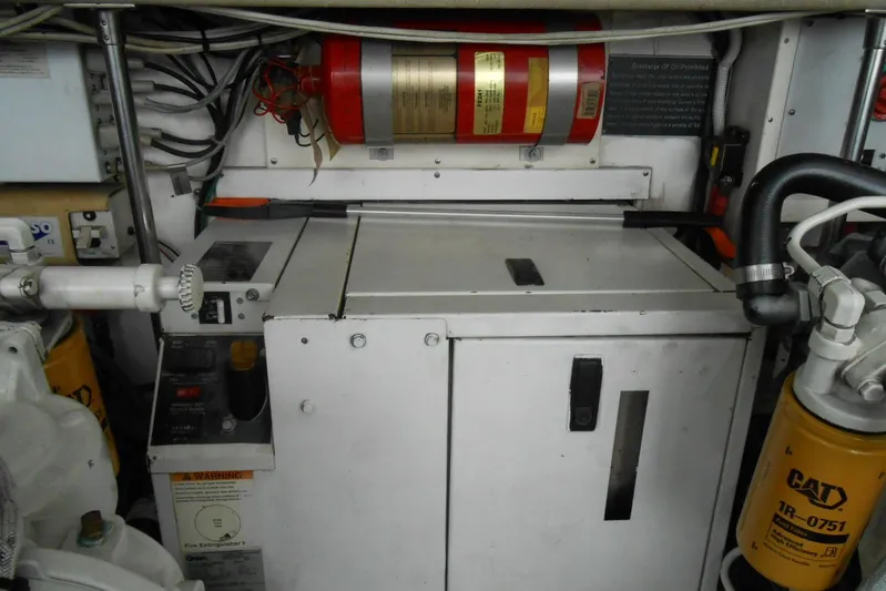 Beer Money Yacht Photos Pics Engine room of 2004 Topaz 32 Express boat with fire extinguisher and CAT filter.