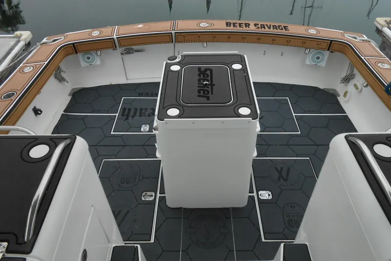 Beer Money Yacht Photos Pics 2004 Topaz 32 Express boat deck with custom flooring and "Beer Savage" branding.