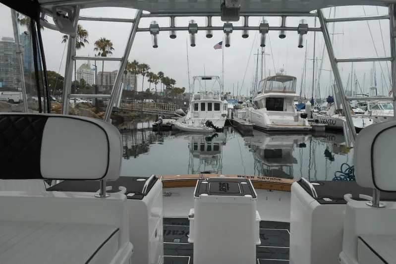 Beer Money Yacht Photos Pics 2004 Topaz 32 Express boat docked in a marina with palm trees and yachts.