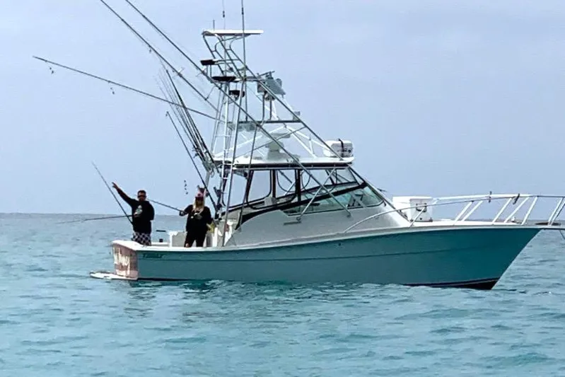 Beer Money Yacht Photos Pics 2004 Topaz 32 Express boat with anglers fishing in open water.