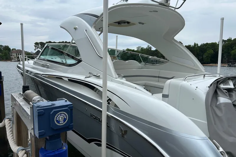  Yacht Photos Pics 2008 Formula 400 Super Sport boat docked by a serene lake.