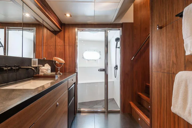  Yacht Photos Pics Luxurious bathroom interior of 2014 Sunseeker 131 yacht with wooden finishes and modern fixtures.