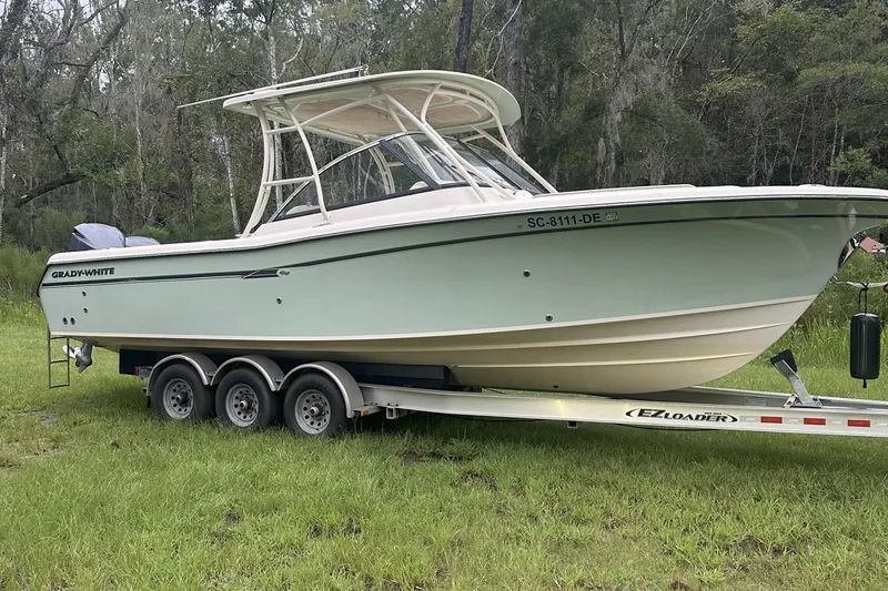 Seas The Day Yacht Photos Pics 2015 Grady-White Freedom 285 boat on trailer in grassy area.