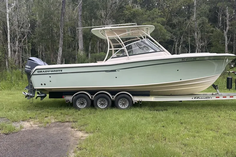 Seas The Day Yacht Photos Pics 2015 Grady-White Freedom 285 boat on trailer in grassy area.