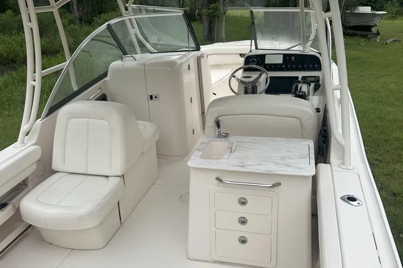 Seas The Day Yacht Photos Pics 2015 Grady-White Freedom 285 boat interior with seating and helm station.
