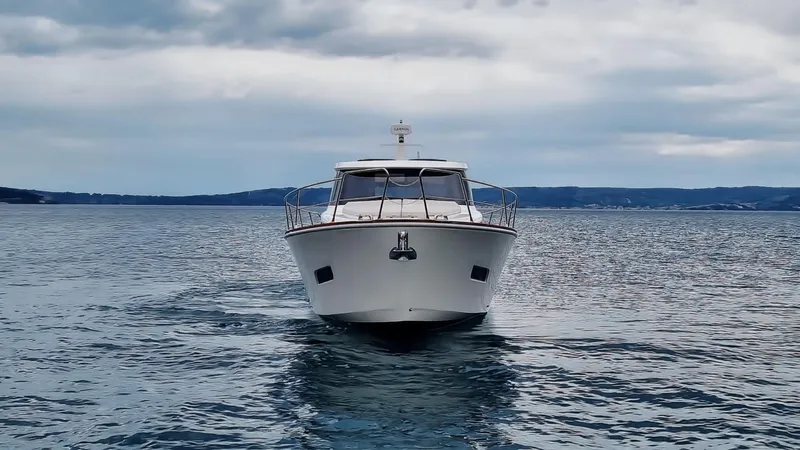 470 Rc Yacht Photos Pics Front view of 2026 Monachus 470 RC yacht on open water under cloudy sky.