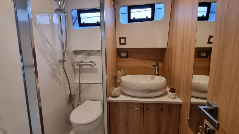 470 Rc Yacht Photos Pics Modern bathroom in 2026 Monachus 470 RC yacht with marble sink and wooden accents.