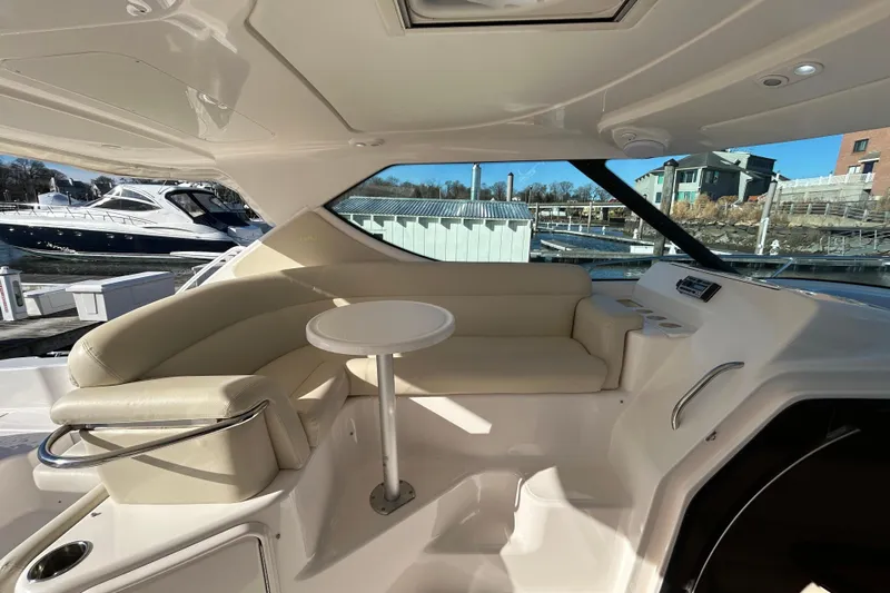  Yacht Photos Pics 2008 Tiara Yachts 3900 Sovran interior with beige seating and table, docked at marina.