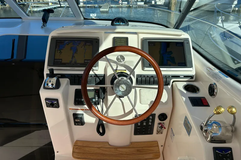  Yacht Photos Pics Helm of 2008 Tiara Yachts 3900 Sovran with dual Garmin displays and wooden steering wheel.