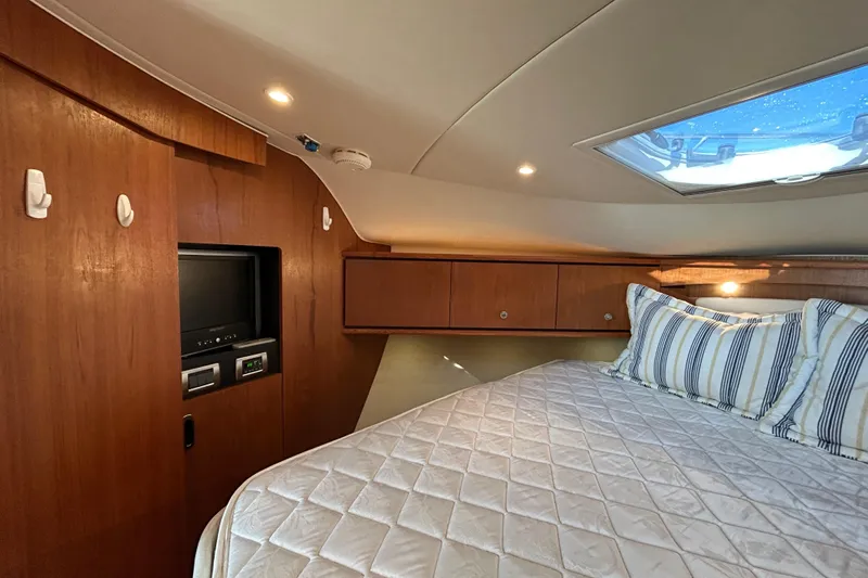  Yacht Photos Pics Luxurious cabin interior of 2008 Tiara Yachts 3900 Sovran with cozy bedding and wood finish.