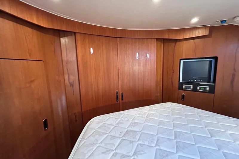  Yacht Photos Pics 2008 Tiara Yachts 3900 Sovran cabin interior with wood paneling and built-in TV.
