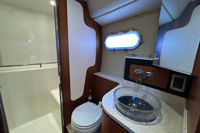  Yacht Photos Pics Luxurious bathroom in 2008 Tiara Yachts 3900 Sovran with modern fixtures and porthole window.