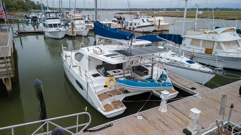 Papillon Yacht Photos Pics 2012 Leopard 39 catamaran docked at marina with sailboats and yachts.
