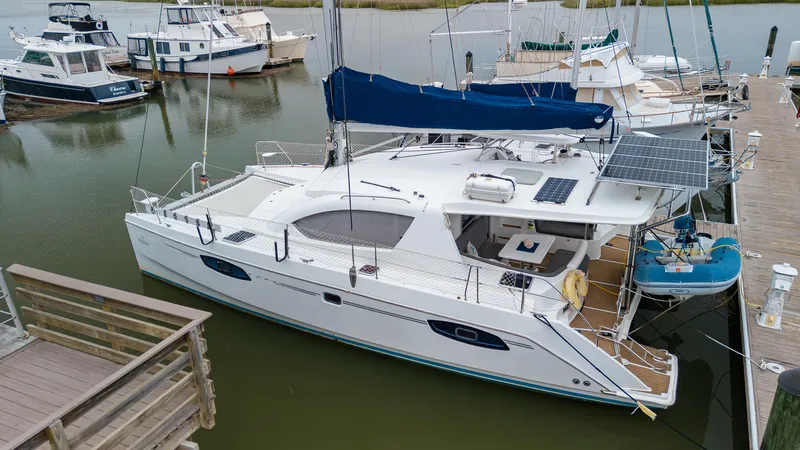 Papillon Yacht Photos Pics 2012 Leopard 39 catamaran docked, featuring solar panels and a sleek design.