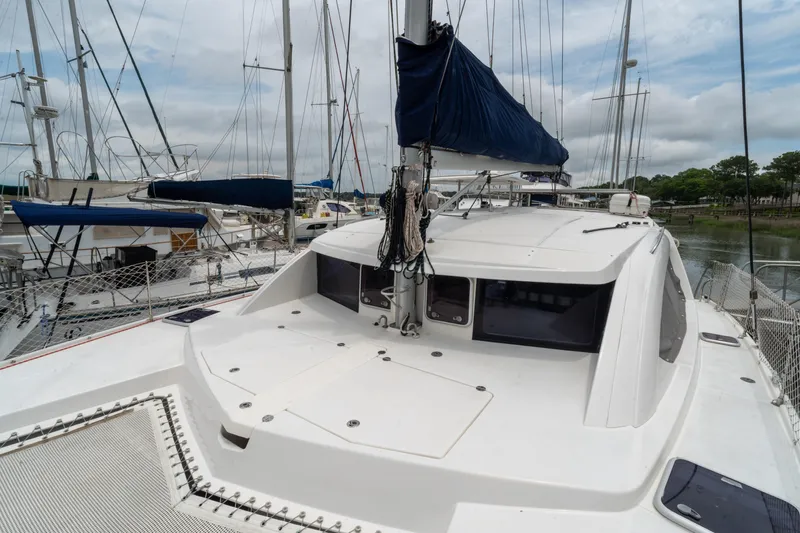 Papillon Yacht Photos Pics 2012 Leopard 39 catamaran docked at a marina, featuring a spacious deck and sleek design.
