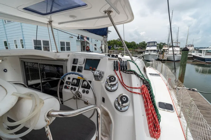 Papillon Yacht Photos Pics Cockpit of 2012 Leopard 39 catamaran docked at marina with colorful ropes and steering wheel.