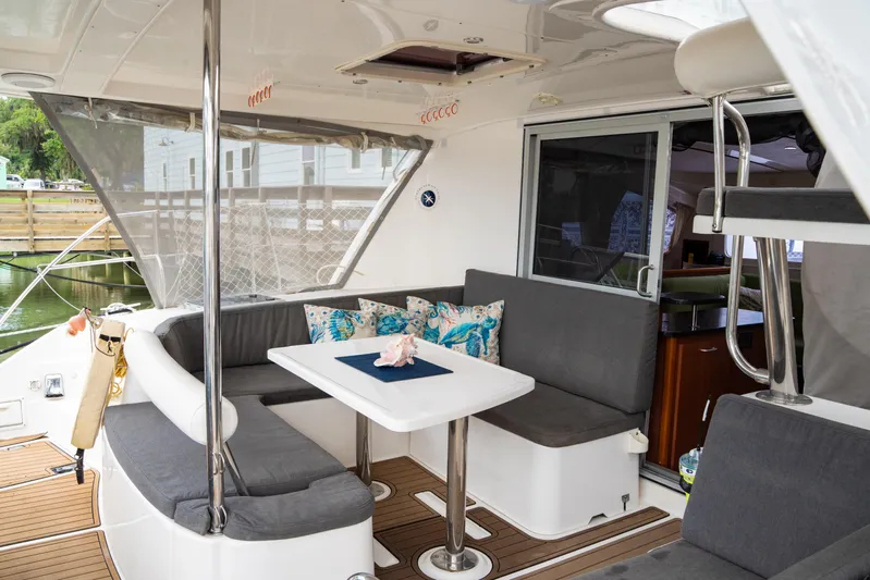 Papillon Yacht Photos Pics Leopard 39 yacht interior, 2012 model, featuring a cozy seating area with a table and cushions.