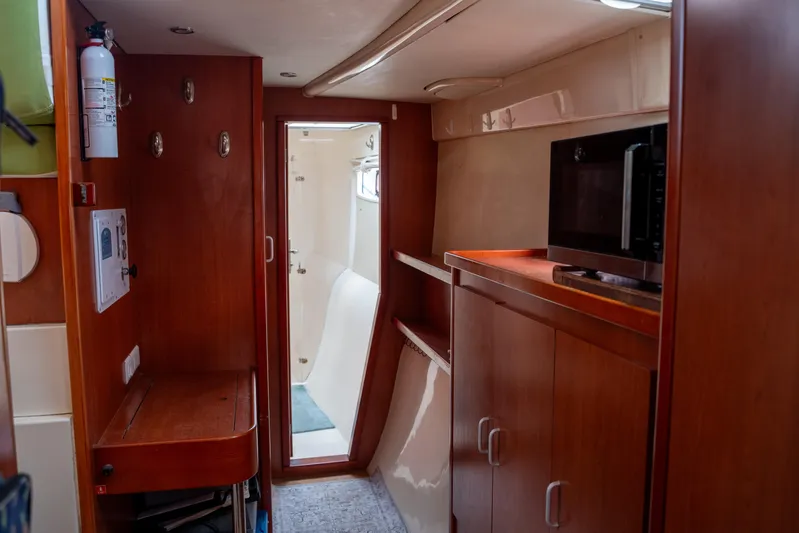 Papillon Yacht Photos Pics Interior of 2012 Leopard 39 yacht with wooden cabinetry and microwave.