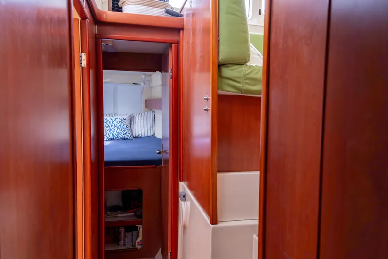 Papillon Yacht Photos Pics Interior of 2012 Leopard 39 yacht, featuring cozy cabin with wooden finish and bedding.